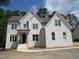 Charming two-story home with white brick, gabled roof, and manicured lawn at 1444 Old Apex Rd, Cary, NC 27513