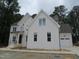 Elegant two-story white brick home with an attached garage and professional signage at 1444 Old Apex Rd, Cary, NC 27513