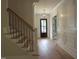 Elegant foyer featuring hardwood floors, staircase, and modern chandelier at 1444 Old Apex Rd, Cary, NC 27513