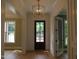 Bright foyer with hardwood floors, stylish lighting, and paneled walls at 1444 Old Apex Rd, Cary, NC 27513