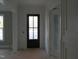 Foyer showcasing paneled wainscoting and a dark wood front door with glass panes at 1444 Old Apex Rd, Cary, NC 27513