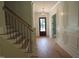 Welcoming foyer showcasing staircase, wood floors, decorative lighting, and detailed trim work at 1444 Old Apex Rd, Cary, NC 27513