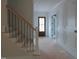 Foyer featuring paneled walls, a staircase, and a front door with glass panes at 1444 Old Apex Rd, Cary, NC 27513