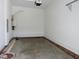 Bright garage with concrete flooring, white walls, and utility fixtures at 1444 Old Apex Rd, Cary, NC 27513