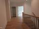 Bright hallway with hardwood floors and open view to additional rooms and storage at 1444 Old Apex Rd, Cary, NC 27513