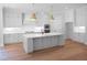 Beautiful kitchen featuring white cabinets, a large island, quartz countertops, and pendant lighting at 1444 Old Apex Rd, Cary, NC 27513