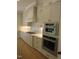 Close-up of a kitchen with stainless appliances, including oven and gas range, and white subway tile backsplash at 1444 Old Apex Rd, Cary, NC 27513