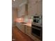 Modern kitchen featuring stainless steel appliances, a gas cooktop, white cabinets, and subway tile backsplash at 1444 Old Apex Rd, Cary, NC 27513