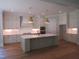 Elegant kitchen features a large island, quartz countertops, stainless steel appliances, and modern pendant lighting at 1444 Old Apex Rd, Cary, NC 27513