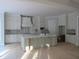 Well-lit kitchen with white cabinets, ample countertop space, and a functional island at 1444 Old Apex Rd, Cary, NC 27513