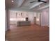 Open-concept kitchen featuring hardwood floors, a large island, stainless steel appliances, and ample cabinet space at 1444 Old Apex Rd, Cary, NC 27513