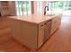 Kitchen island features seating, white countertop, stainless dishwasher, and modern black faucet at 1444 Old Apex Rd, Cary, NC 27513