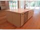Kitchen island with stone countertops, stainless steel dishwasher, and ample storage in an open floor plan at 1444 Old Apex Rd, Cary, NC 27513