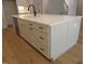 Kitchen island with light cabinets, black hardware, ample storage, and a white countertop at 1444 Old Apex Rd, Cary, NC 27513