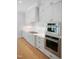 Close up of kitchen featuring stainless steel KitchenAid oven and cooktop and white cabinetry at 1444 Old Apex Rd, Cary, NC 27513