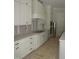 Detailed view of the kitchen featuring custom white cabinetry and modern hardware at 1444 Old Apex Rd, Cary, NC 27513