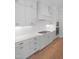 Bright kitchen featuring stainless steel appliances, including oven and cooktop, and hardwood floors at 1444 Old Apex Rd, Cary, NC 27513