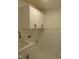A clean laundry room with white shaker cabinets, a stainless steel sink, and light tiled flooring at 1444 Old Apex Rd, Cary, NC 27513