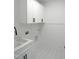 Clean laundry room with white cabinetry, contrasting hardware and updated appliances at 1444 Old Apex Rd, Cary, NC 27513