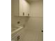 Well-lit laundry room features ample storage with white cabinets, matte black hardware, and convenient sink at 1444 Old Apex Rd, Cary, NC 27513