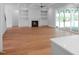 Spacious open living room featuring a fireplace, built-in shelving, and sliding doors to outdoor patio at 1444 Old Apex Rd, Cary, NC 27513