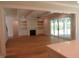 Spacious living room featuring built-in bookshelves, a fireplace, and sliding doors to the outdoor area at 1444 Old Apex Rd, Cary, NC 27513
