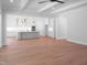 Open concept living space with a kitchen in the background with coffered ceilings and modern lighting at 1444 Old Apex Rd, Cary, NC 27513