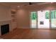 Living room with fireplace and built-ins and sliding glass doors to outdoor patio at 1444 Old Apex Rd, Cary, NC 27513