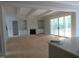 Bright living room with fireplace, built-ins, and sliding doors to the outside at 1444 Old Apex Rd, Cary, NC 27513