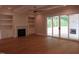 Open-concept living room featuring a fireplace, built-in shelves, and sliding glass doors to the patio at 1444 Old Apex Rd, Cary, NC 27513
