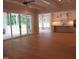 Spacious open-concept living room with hardwood floors, leading to a modern kitchen and outdoor patio at 1444 Old Apex Rd, Cary, NC 27513