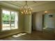 Sunlit living room with chandelier, large window, and craftsman trim at 1444 Old Apex Rd, Cary, NC 27513