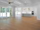Open concept living space with a kitchen in the background and sliding doors to a patio at 1444 Old Apex Rd, Cary, NC 27513