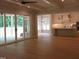 Open concept living room, with access to the patio and kitchen, with hardwood floors at 1444 Old Apex Rd, Cary, NC 27513
