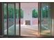View of patio with fireplace through sliding glass doors at 1444 Old Apex Rd, Cary, NC 27513