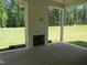 Covered patio features a brick fireplace and outdoor living space overlooking the green backyard at 1444 Old Apex Rd, Cary, NC 27513