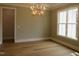 Bright room with hardwood floors, modern lighting, and neutral wall colors at 1444 Old Apex Rd, Cary, NC 27513