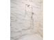 Elegant marble shower with multi-setting showerhead and built-in niche for storage at 1444 Old Apex Rd, Cary, NC 27513