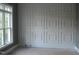 Wall showcasing square paneled wainscoting detail next to a large window at 1444 Old Apex Rd, Cary, NC 27513