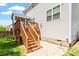 Backyard features a wooden deck with stairs leading down to a patio and spacious lawn at 1613 Waddell Ct, Durham, NC 27703