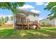 Expansive backyard shows screened porch, wooden deck with stairs, and plenty of green space at 1613 Waddell Ct, Durham, NC 27703