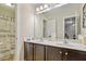 Bathroom featuring double sinks, stylish cabinets, and a shower with a unique shower curtain at 1613 Waddell Ct, Durham, NC 27703