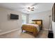 Comfortable bedroom with neutral walls, ceiling fan, and a TV for relaxing and enjoying the space at 1613 Waddell Ct, Durham, NC 27703