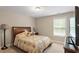 Comfortable bedroom featuring a large window and soft, natural light, perfect for relaxation at 1613 Waddell Ct, Durham, NC 27703