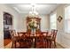 Formal dining room with elegant chandelier, wainscoting, and a beautiful wood table with seating at 1613 Waddell Ct, Durham, NC 27703