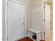 Functional entryway with coat rack, bench with storage, and access to a closet and bathroom at 1613 Waddell Ct, Durham, NC 27703