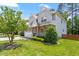 Charming two-story home with a well-manicured lawn, a two-car garage, and attractive landscaping at 1613 Waddell Ct, Durham, NC 27703