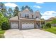 Stunning two-story home with stone accents, a spacious three-car garage, and a beautifully landscaped front yard at 1613 Waddell Ct, Durham, NC 27703
