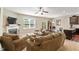Spacious living room with fireplace, carpet floors, fan, and lots of natural light at 1613 Waddell Ct, Durham, NC 27703