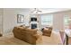 Inviting living room with a cozy fireplace, neutral decor, ceiling fan, and lots of natural light at 1613 Waddell Ct, Durham, NC 27703